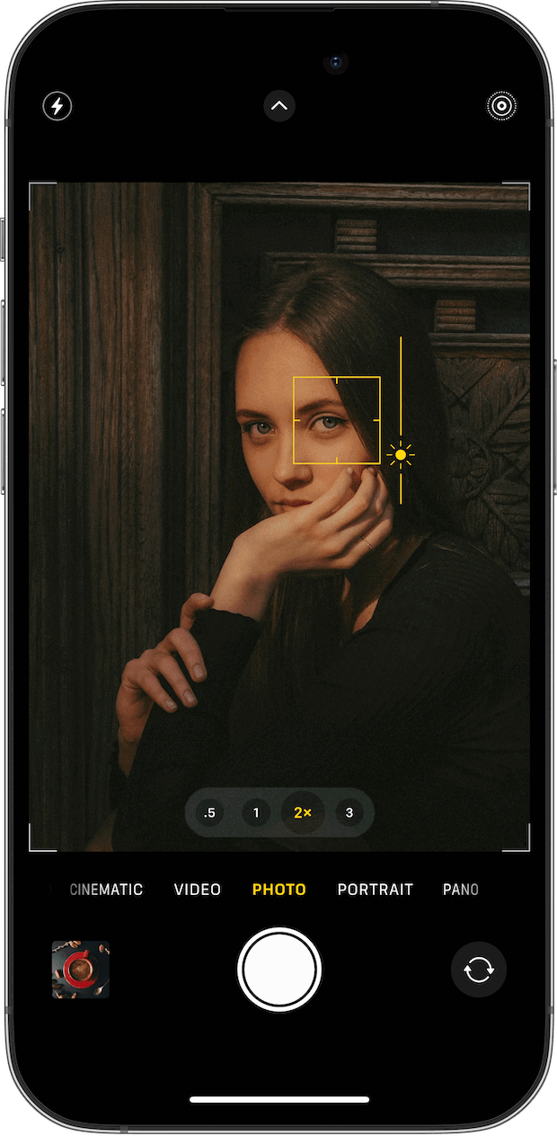 The iPhone camera screen with the focus box and a sun icon for adjusting exposure.