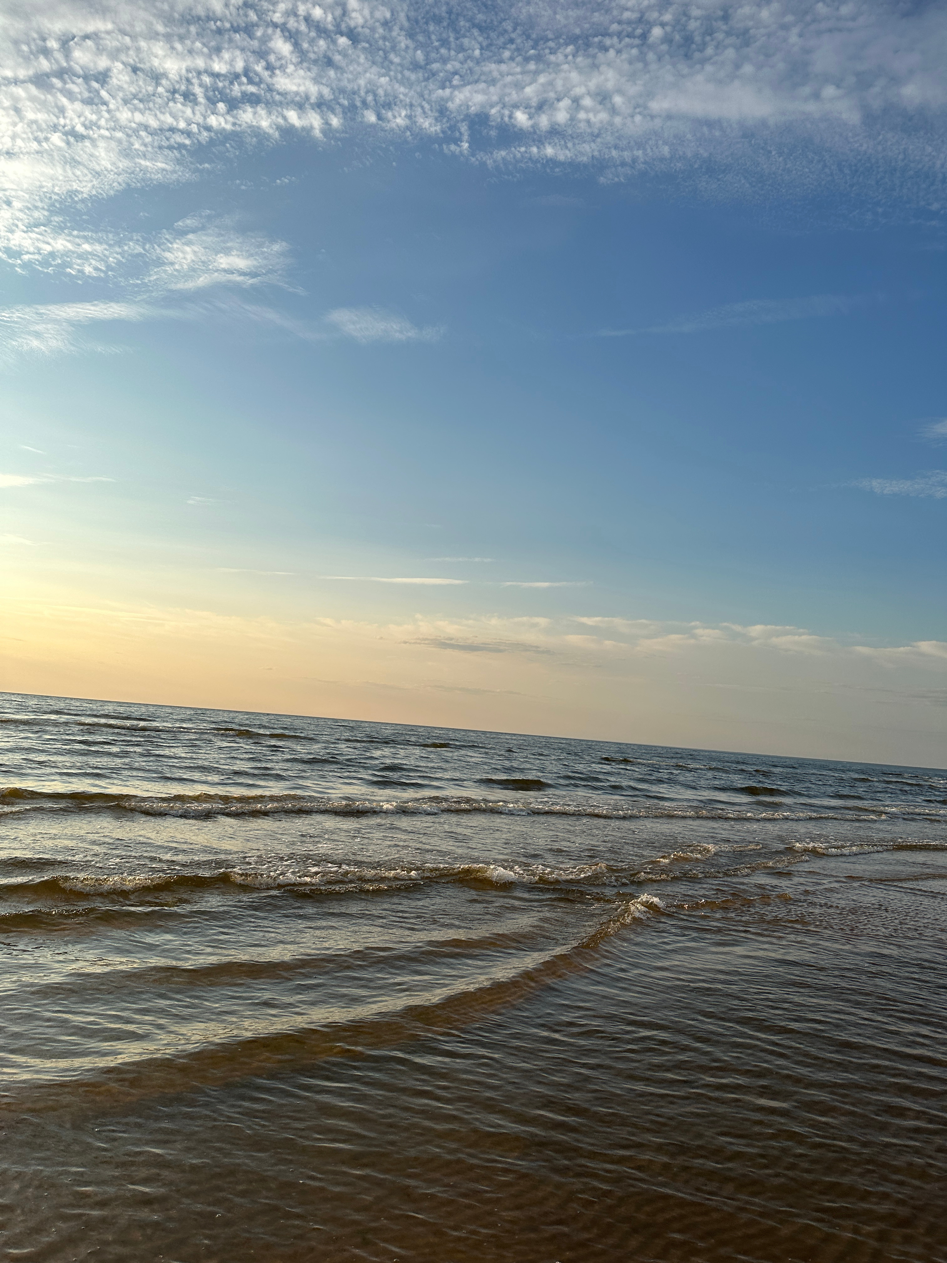 A calm sea and sky at dusk with no clear subject.