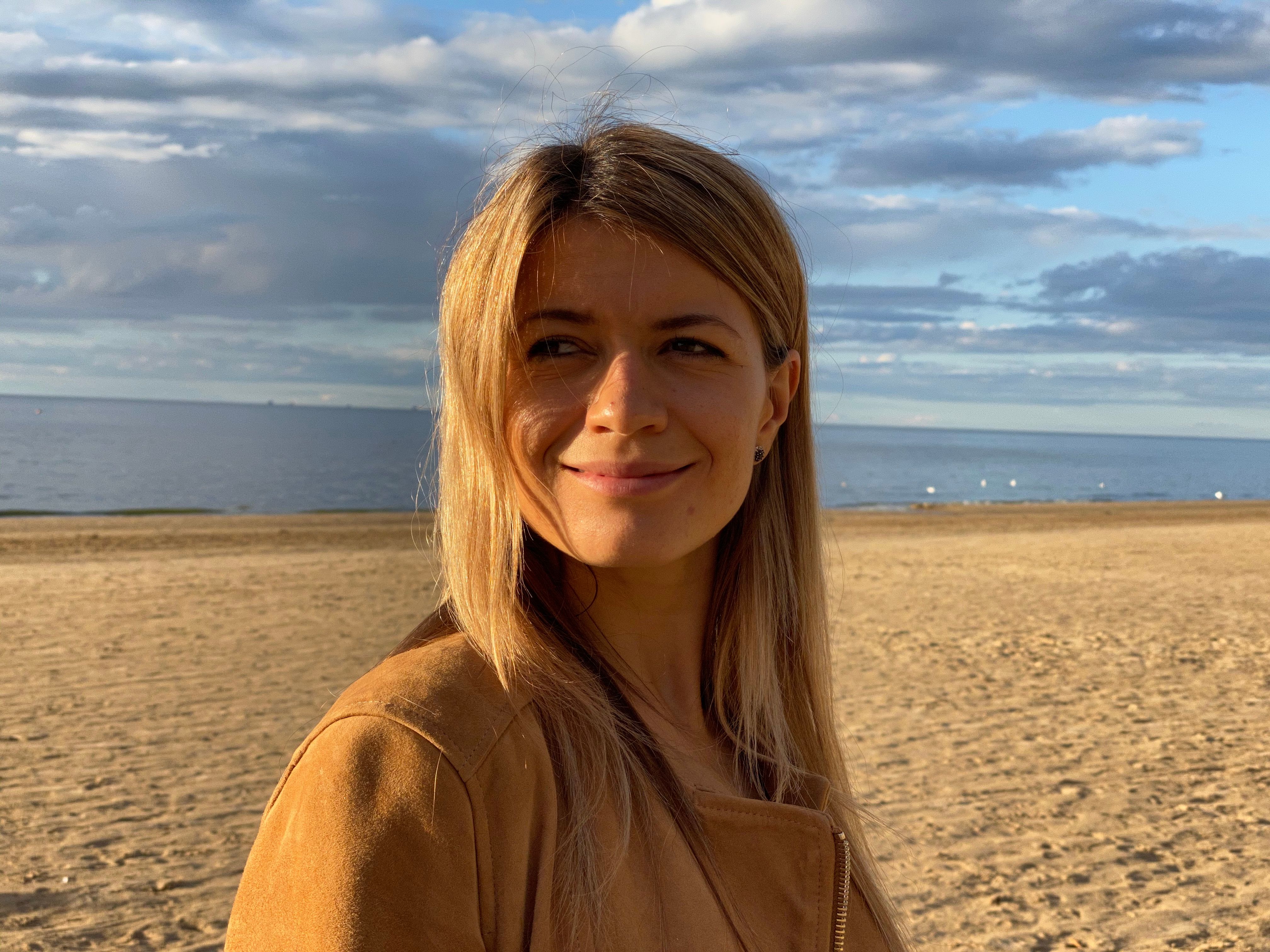 A beach portrait in harsh, direct sun with hard shadows on the face.