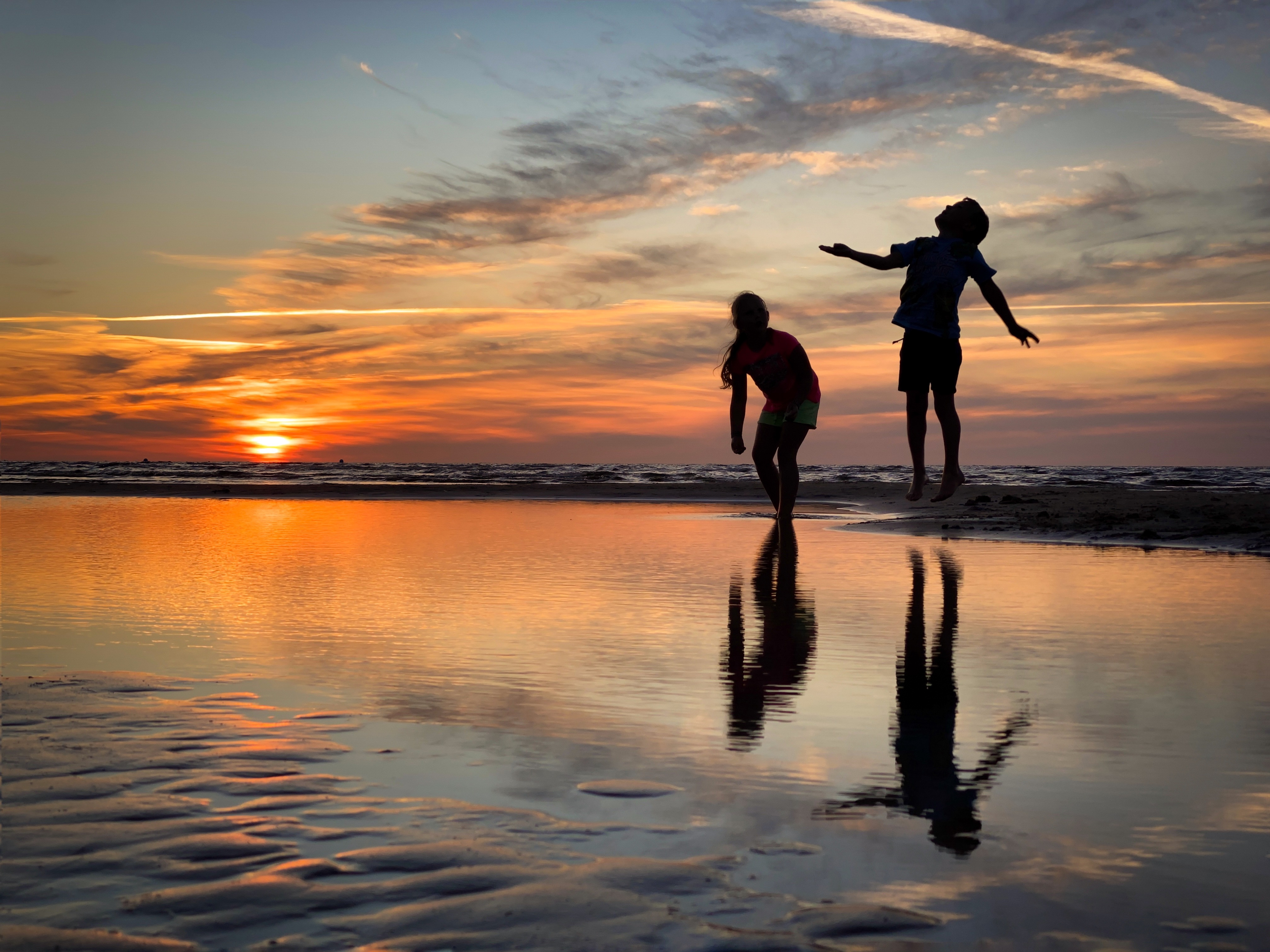 Children playing on a beach, framed off-center using the rule of thirds.