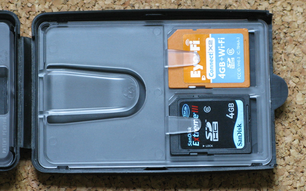 Several SD and microSD memory cards arranged on a neutral surface, showing their printed speed ratings.